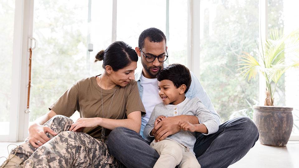 Couple sitting with a child in their home